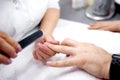 Experienced hands of a manicurist take care of manÃ¢â¬â¢s nails Royalty Free Stock Photo