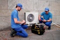 Experienced Hispanic HVAC Technician Installing Commercial Air Conditioning Royalty Free Stock Photo