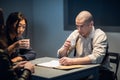 An experienced investigator and a female police officer interrogate the suspect Royalty Free Stock Photo