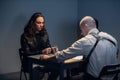 An experienced investigator and his assistant conduct an interview at the police station