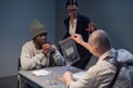 An experienced investigator during the interrogation shows the alleged criminal and his lawyer evidence of the crime Royalty Free Stock Photo