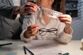 Experienced investigator showing criminal evidence of crime committed. Close up of to detective holding evidence glasses Royalty Free Stock Photo