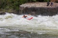 Adventurous kayaker paddling through the rough rapids on the Gauley River in West Virginia