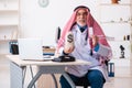 Old male arab doctor holding moneybag