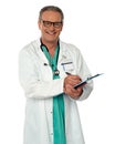 Experienced male doctor making report Royalty Free Stock Photo