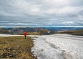 Experienced male hiker hiking alone into the wild admiring volcanic landscape with colorful mountains and snow with big, heavy Royalty Free Stock Photo