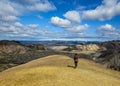 Experienced male hiker hiking alone into the wild admiring volcanic landscape with heavy backpack. Travel lifestyle adventure Royalty Free Stock Photo