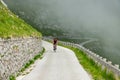 Experienced male road cyclist is training for a race in the misty Julian Alps.