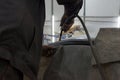 Experienced man performs work on body repair car with a welding machine.