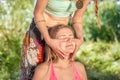 Girl performs massage in a forest clearing. Royalty Free Stock Photo