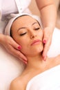Experienced masseuse hands massaging a face of a woman Royalty Free Stock Photo