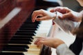 Experienced master piano hand helps the student Royalty Free Stock Photo