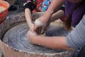 An experienced worker teaches the girl to work on a Potter`s wheel Royalty Free Stock Photo