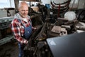 Experienced middle-aged worker is making car repairs Royalty Free Stock Photo