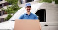 Experienced Mover Smiling While Carrying Boxes From Commercial Van Royalty Free Stock Photo