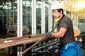 Experienced operator technician Caucasian male, Working by preparing steel, copper pipes Which are raw materials used industrial a Royalty Free Stock Photo