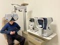 Experienced optometrist doing sight test for senior man at modern ophthalmology clinic. Eye exam and vision diagnostic