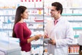 Experienced pharmacist counseling female customer Royalty Free Stock Photo