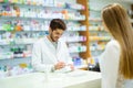 Experienced pharmacist counseling female customer in pharmacy Royalty Free Stock Photo