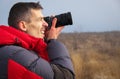 An experienced photographer takes pictures in nature. A professional video maker shoots scenes in cloudy weather Royalty Free Stock Photo
