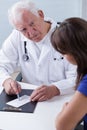 Experienced physician giving prescription