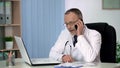 Experienced physician talking on phone, consulting patient about treatment