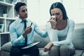 Experienced psychologist listens attentively to frustrated woman.