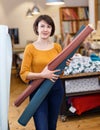 Saleswoman arranging fabric bolts