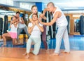 Self-defense instructor teaching women to perform guillotine choke Royalty Free Stock Photo