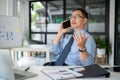 Experienced senior businessman having a serious phone call with his employee while sitting in the office room Royalty Free Stock Photo