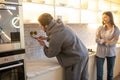 Experienced serviceman installing the outlet on the kitchen wall Royalty Free Stock Photo