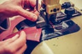 Experienced shoemaker uses a special machine for thinning of the leather, in the footwear industry