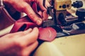 Experienced shoemaker uses a special machine for thinning of the leather