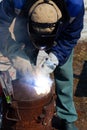 An experienced welder at work. Preparation and welding process of cast iron furnace. Selection focus. Shallow depth of field Royalty Free Stock Photo