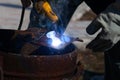 An experienced welder at work. Preparation and welding process of cast iron furnace. Selection focus. Shallow depth of field Royalty Free Stock Photo