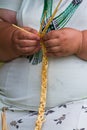 Experienced woman hands plait handmade straw bag detail, traditional ancient craft fashion, Living Fire Midsummer Pagan Ethno fest