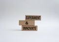 Experiment and innovate symbol. Concept words Experiment and innovate on wooden blocks. Beautiful white background. Business and
