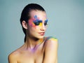 Experimenting with aesthetics. Studio shot of an attractive young woman with brightly colored makeup against a blue