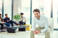 The expert in anything was once a beginner. Portrait of a confident young businessman sitting in an office with Royalty Free Stock Photo