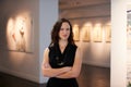 Expert, arms crossed and portrait of a woman at an art gallery for an exhibition. Creative, culture and a museum manager Royalty Free Stock Photo