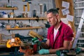 Expert carpenter burning a wood leg with a professional gas burner. Flames and smoke, fire and timber. Portrait of Royalty Free Stock Photo