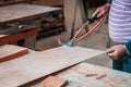 Expert carpenter burning a wood slab with a professional gas burner. Flames and smoke, fire and timber.