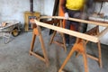 expert Carpenter worker during painting of an old wooden frame