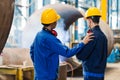 Expert checking the quality of manufactured boilers Royalty Free Stock Photo