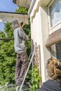 Expert craftsman is repairing a balcony awning