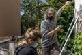 Expert craftsman is repairing a balcony awning