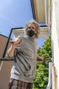 Expert craftsman is repairing a balcony awning