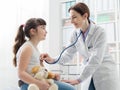 Female doctor examining a girl with a stethoscope