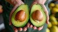The Expert Hands: Capturing the Perfect Halves of Ripe Hass Avocado - An Insight into Female Fruit S