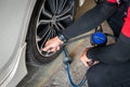 Expert mechanic checks tire pressure with nitrogen